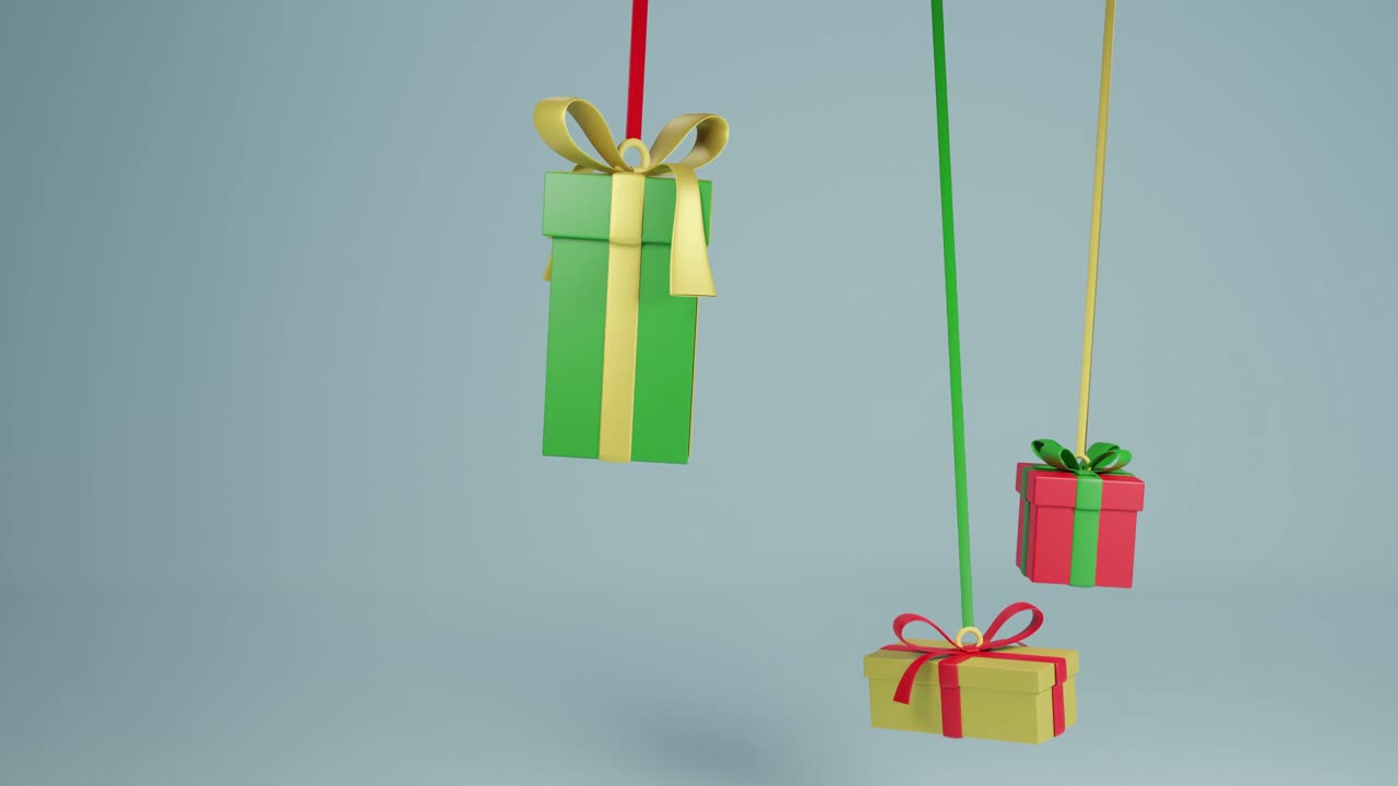 Video of three christmas presents hanging with ribbons with copy space over grey background