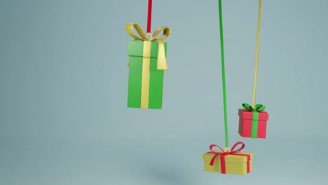 Video-of-three-christmas-presents-hanging-with-ribbons-with-copy-space-over-grey-background