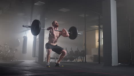 Slow-motion-of-crossfit-athlete-performs-clean-and-jerk.-Young-man-doing-the-clean-and-jerk-weightlifting-exercise-at-the-gym.