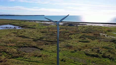 aerial of wind turbine creating renewable energy in waterford, ireland