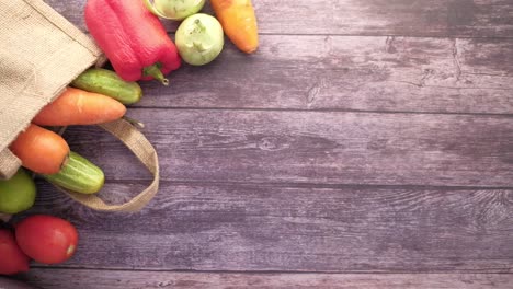 person in gloves picking vegetables from a bag