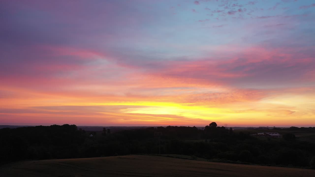 Aerial View of Vibrant Sunset Sky Over Rural Landscape