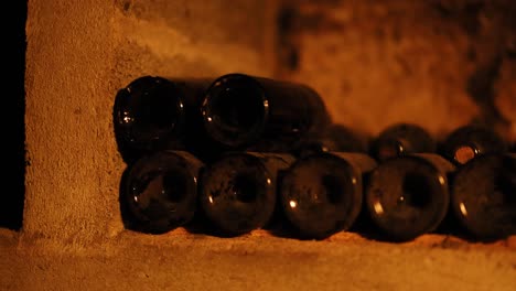 wine bottles aging in a dimly lit cellar