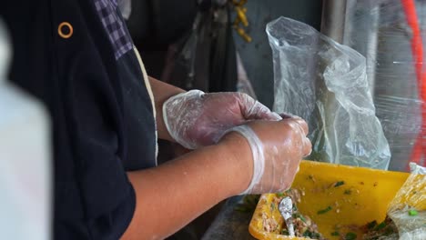 Handmade-authentic-Xian-Bing-meat-pie,-a-stall-vendor-filling-a-dough-pastry-with-minced-pork-and-spring-onions-folding-and-sealing-it-to-perfection,-close-up-shot-of-Taiwanese-popular-street-food