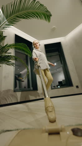 woman mopping the floor in a modern home at night