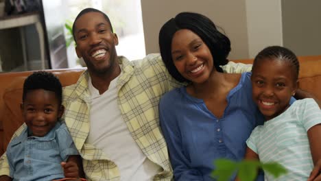 family sitting together in living room 4k