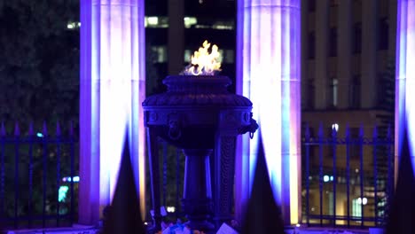 Shrine-of-remembrance-and-eternal-flame-burning-at-its-heart,-Anzac-Square-war-memorial-parklands-at-Brisbane-city,-Queensland,-Australia,-handheld-motion-shot