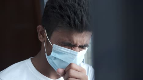 man wearing mask coughing