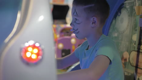 kid playing sea-battle simulator in amusement park