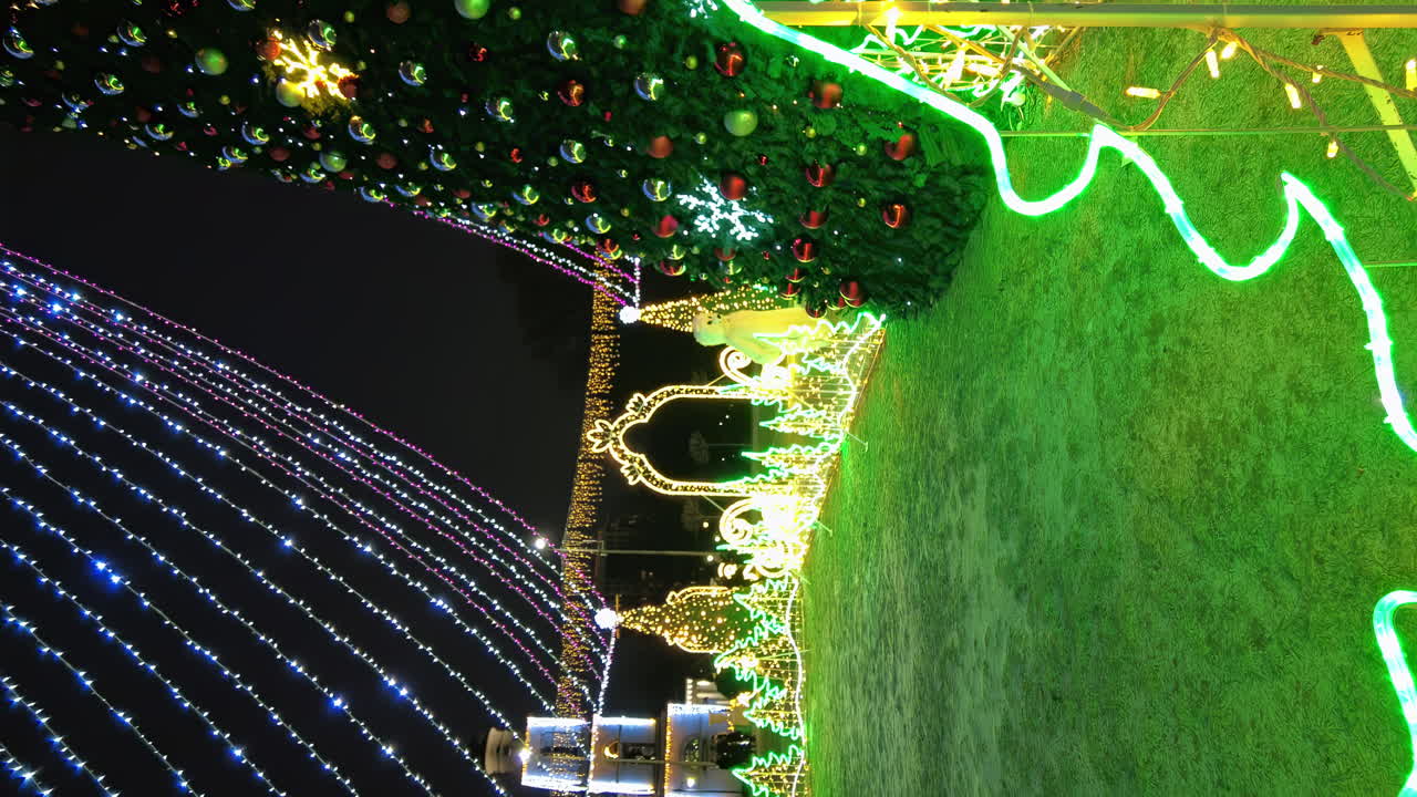 Chisinau, Moldova - December 20, 2021: Bright lights create a magical atmosphere in the park as families enjoy the winter celebration. Beautiful designs adorn the grassy areas, inviting everyone to explore