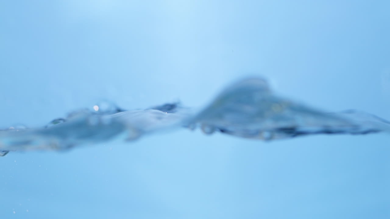 Underwater bubbles rise and shimmer, reflecting light and capturing the fluidity and motion of fresh, pure water in nature.