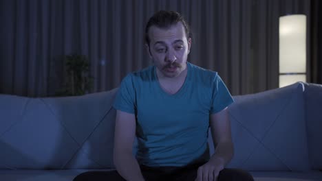 man with insomnia problem standing at home at night.