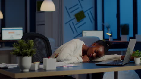 exhausted overload african business woman falling asleep on desk