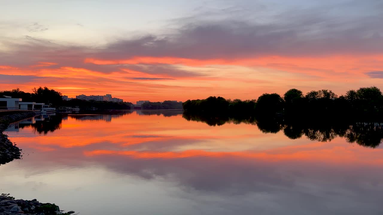Very colorful sunrise over the river (4K 60 fps, in motion)