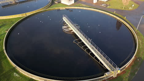 aerial view rising over trickle filtration tanks in sewage waste treatment facility