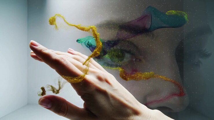 Entering hand pulling colored ribbons across female face on glass in corner studio guiding color