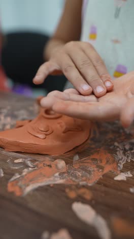 child sculpting with clay