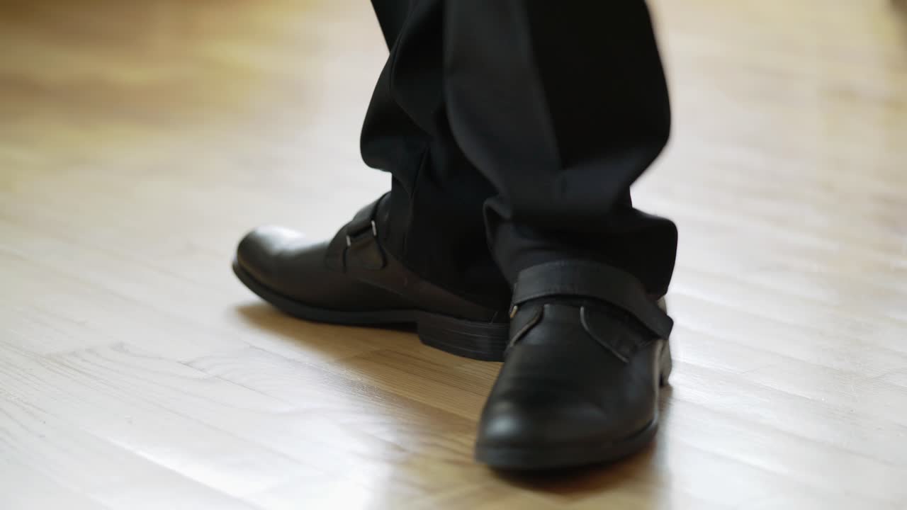 man in black shoes and trousers is making steps forward and going away