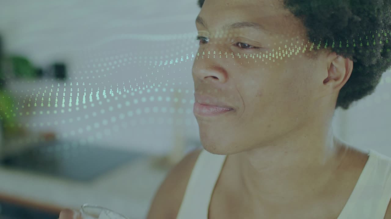 Man lifting glass bottle, sipping beverage in kitchen, dotted overlay crossing face showing relief