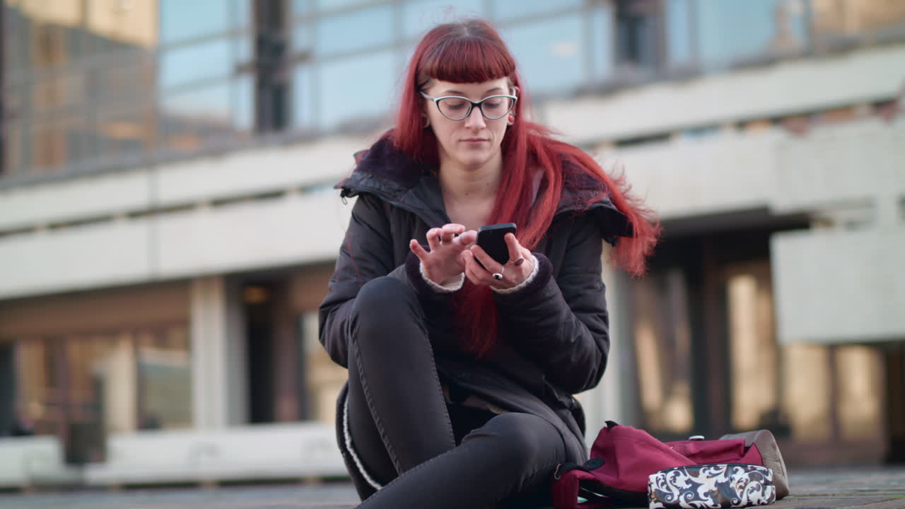 Hipster student can't find the answer she's looking for in book so searching online using her phone.