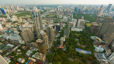 aerial view of ploenchit junction with cars traffic skyscraper buildings. bangkok city in downtown at night, thailand