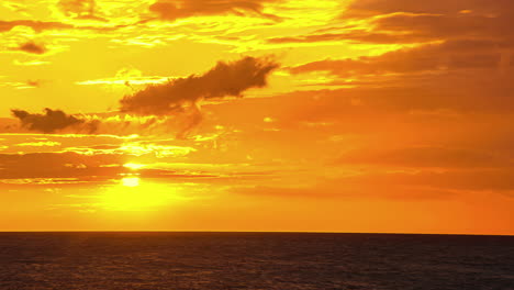 time lapse: beautiful yellow sunrise over seascape with blowing clouds at colored sky