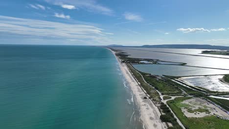 maguelone shore at mediterranean coast of france with natural preserve lagoons, aerial flyover shot