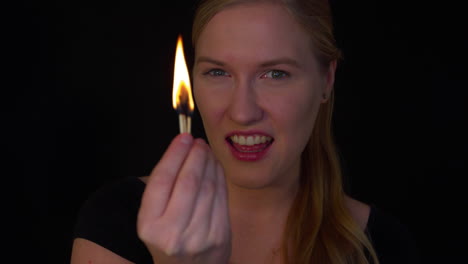 young woman is playing with a fire