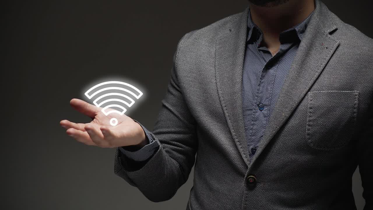 concept of wifi networks. business person teaches wifi network hologram
