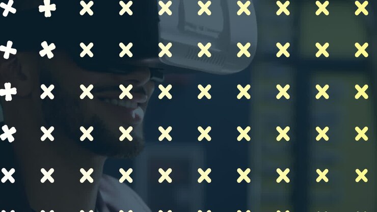 Animation of cross symbols pattern design over close up of biracial man wearing vr headset at office