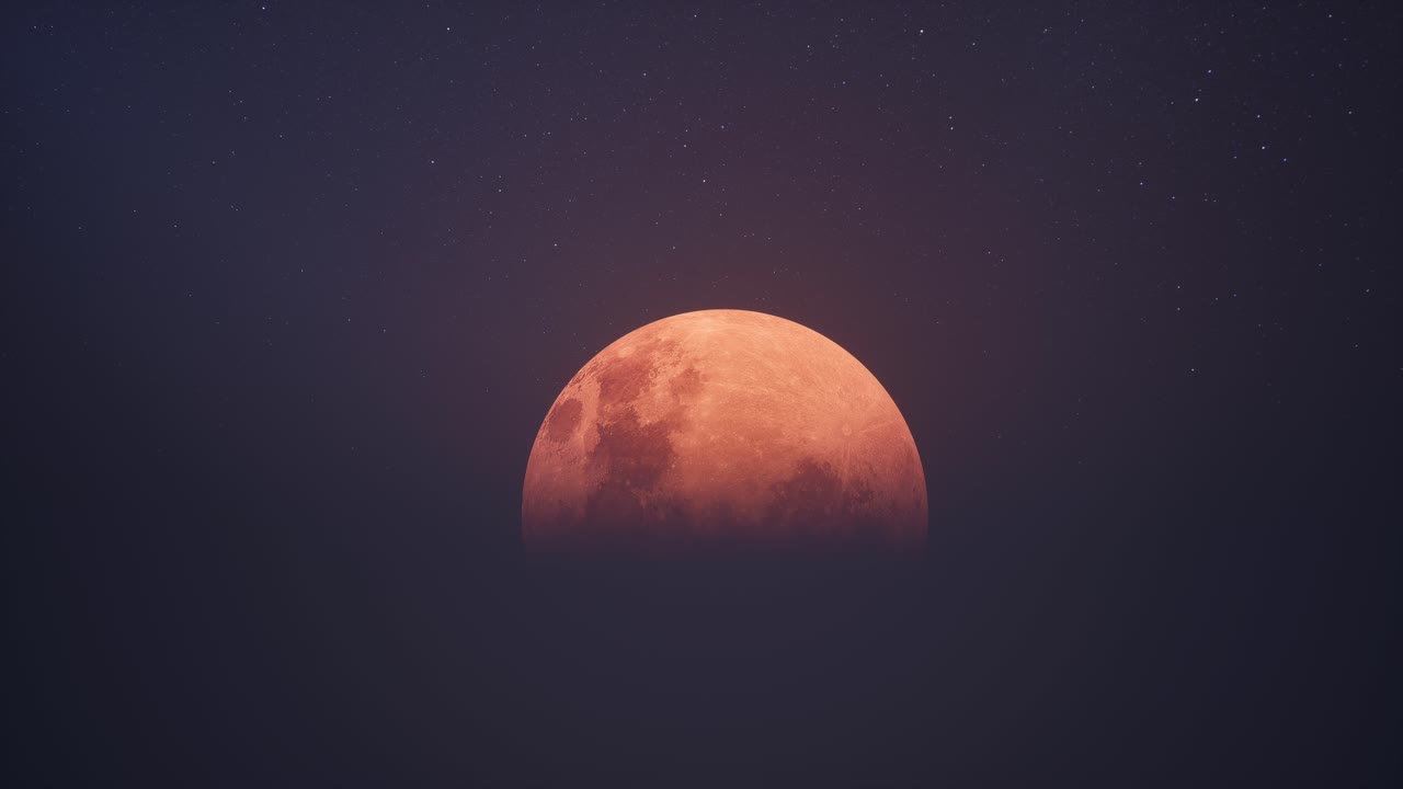 Closeup Of Large Red Blood Moon Rising In A Dark, Starry Sky
