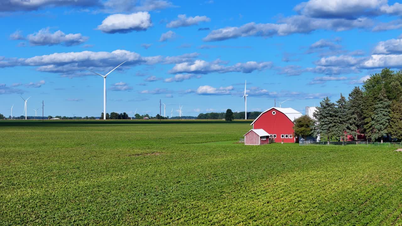 Bredt landbrugsområde med rød lade og vindmøller nær Ithaca, Michigan, USA i luftfoto