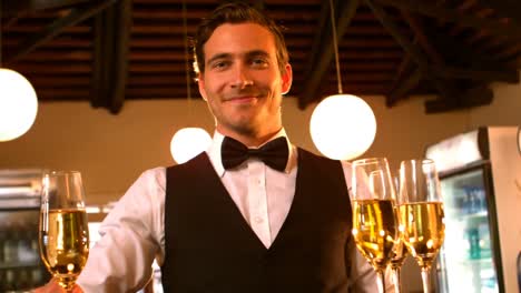 male waiter serving a glass of champagne