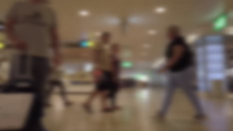 unfocused static shot of people walking in an airport