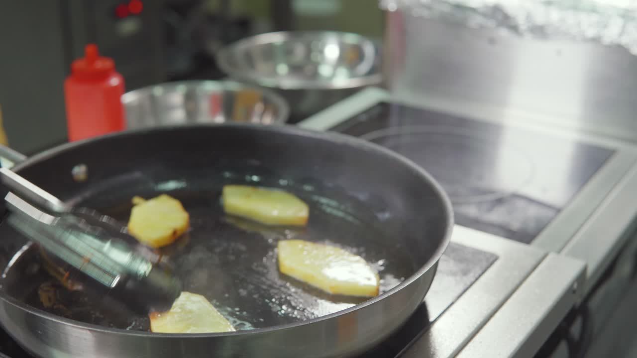 Frying Pineapple Slices in a Kitchen