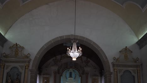baroque style church ceiling and altar with glowing chandelier