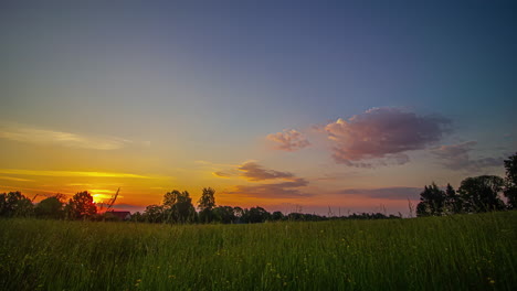 Early-morning-to-dusk-sunset-time-lapse-over-rural-landfield