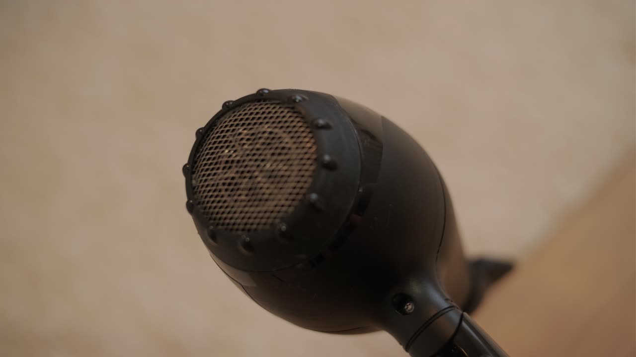 Close-up of a Black Hairdryer Blowing Air