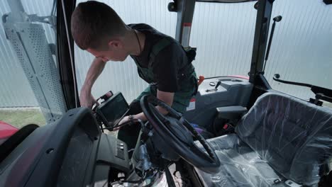 farmer mechanic repairing tractor. open tractor hood, engine. repair agricultural technology