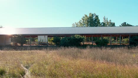 Abandoned-race-track-stable---pushing-outward-from-inside-with-drone