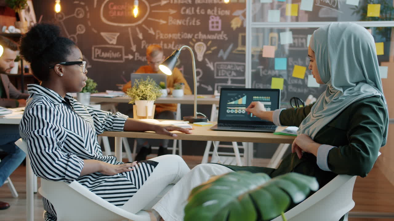 Businesswomen in Meeting Discussing Data