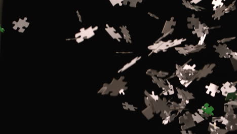 jigsaw pieces falling on black background