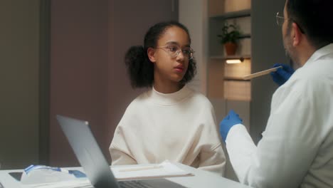 doctor examining a child's throat