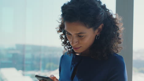 independent-business-woman-using-smartphone-texting-female-executive-checking-emails-browsing-messages-on-mobile-phone-in-office