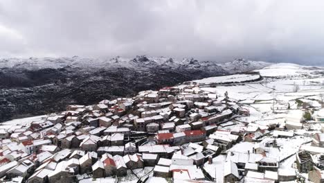 Village-with-snow-capped-mountains-Aerial-View