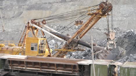 mining excavator loading ore onto train