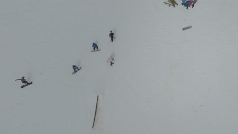 drone top-down view of snowboarders on the snowy slopes of mount hermon, golan heights, israel