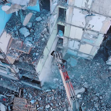 heavy machinery dismantling the old building. excavator disassembling the ruins of the construction. view from above