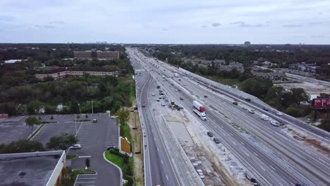 slow forward moving aerial drone shot of busy highway showing vehicular traffic