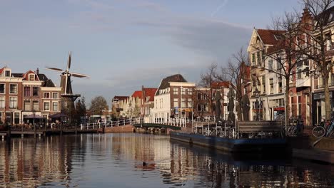 functionerende windmolen met wieken die draaien in een stedelijk tafereel van de oude historische stad leiden in nederland